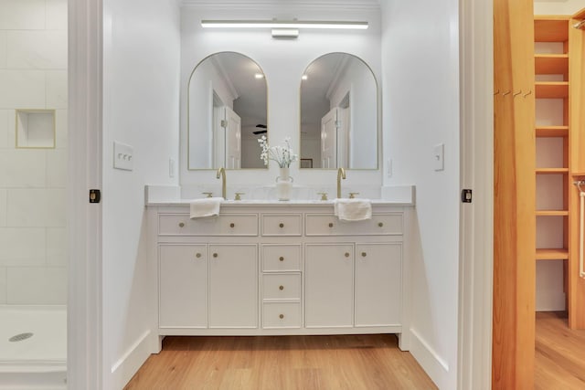 bathroom featuring vanity, hardwood / wood-style floors, and walk in shower