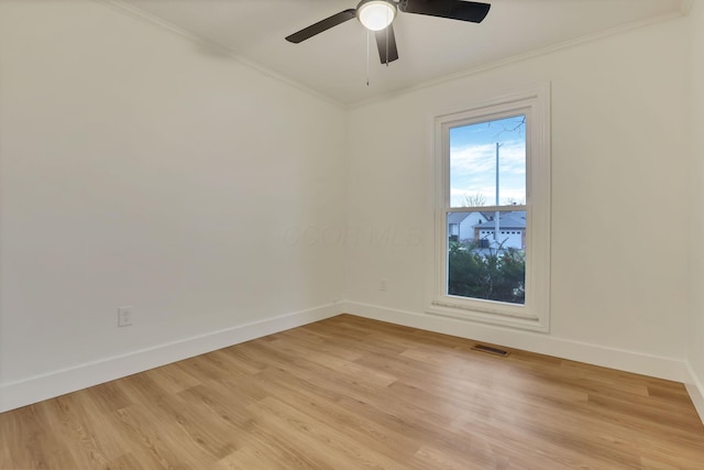 empty room featuring crown molding, light hardwood / wood-style flooring, and ceiling fan