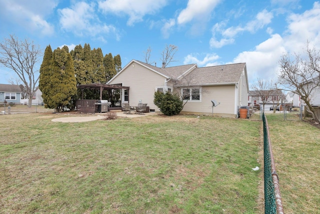 rear view of property featuring a hot tub, a patio, a yard, and a pergola