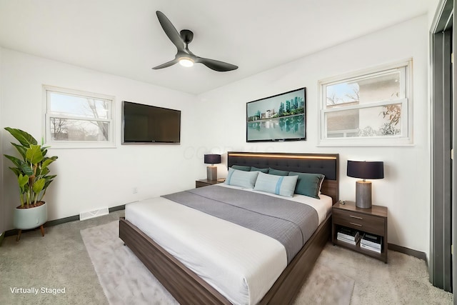 bedroom featuring light carpet and ceiling fan