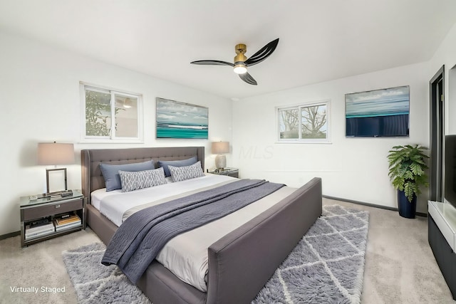 bedroom featuring light carpet and ceiling fan