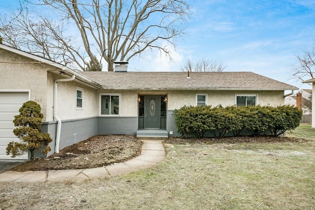 view of front of property with a garage and a front yard