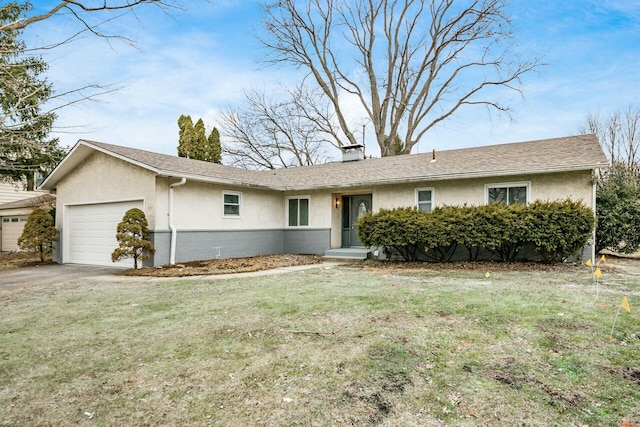 single story home featuring a garage and a front lawn