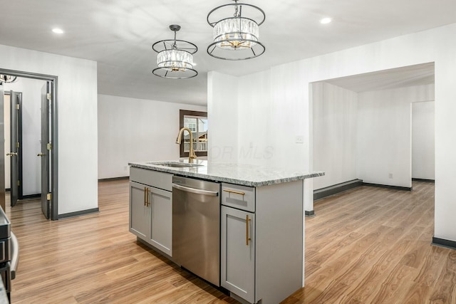 kitchen with gray cabinets, dishwasher, an island with sink, sink, and hanging light fixtures