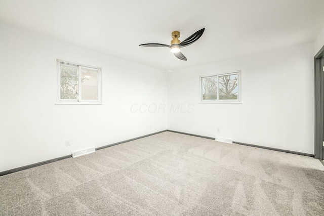 carpeted empty room featuring ceiling fan