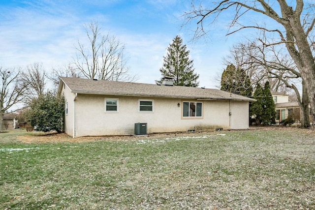 view of side of property featuring cooling unit and a lawn