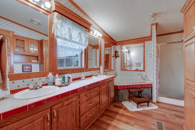 bathroom featuring crown molding, shower with separate bathtub, a textured ceiling, vanity, and hardwood / wood-style flooring