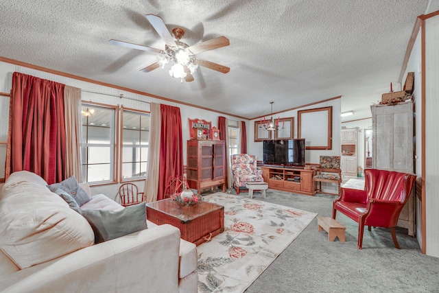 carpeted living room featuring ceiling fan with notable chandelier, ornamental molding, vaulted ceiling, and a textured ceiling