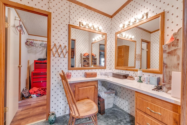 bathroom with ornamental molding, hardwood / wood-style floors, vanity, and a textured ceiling