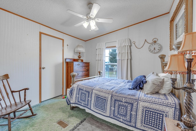 carpeted bedroom with crown molding, vaulted ceiling, ceiling fan, and a textured ceiling