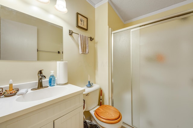 bathroom with crown molding, a shower with door, vanity, a textured ceiling, and toilet