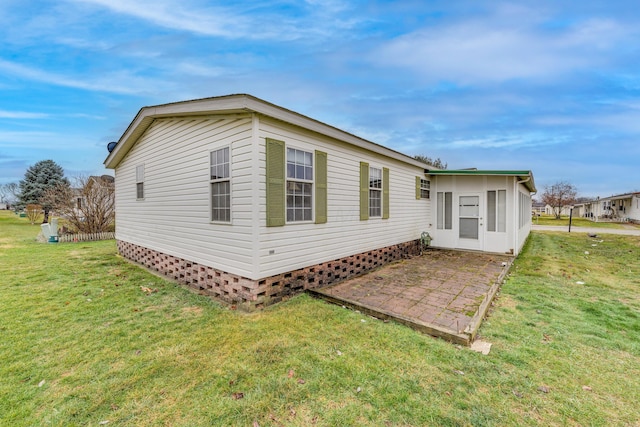 back of property featuring a yard and a patio area