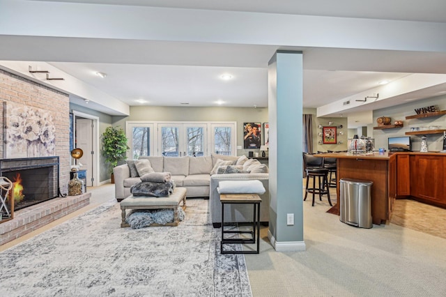 living room with a fireplace and light colored carpet