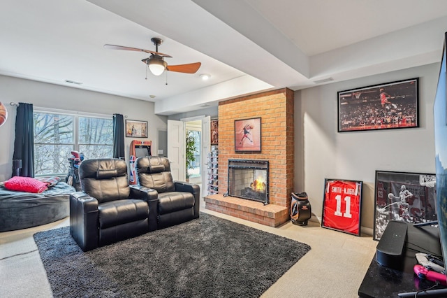 living room featuring a brick fireplace, light colored carpet, and ceiling fan