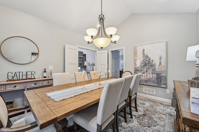 dining room featuring lofted ceiling and a notable chandelier