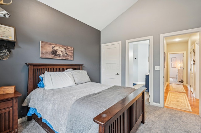 bedroom with high vaulted ceiling and light carpet