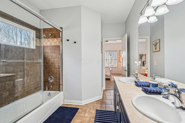 bathroom featuring vanity, enclosed tub / shower combo, and a healthy amount of sunlight