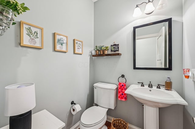 bathroom featuring toilet and sink