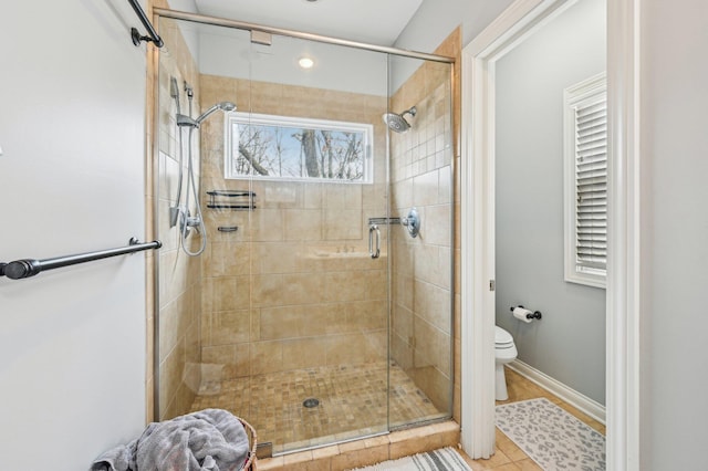 bathroom with an enclosed shower and toilet