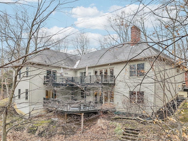 back of property featuring a balcony