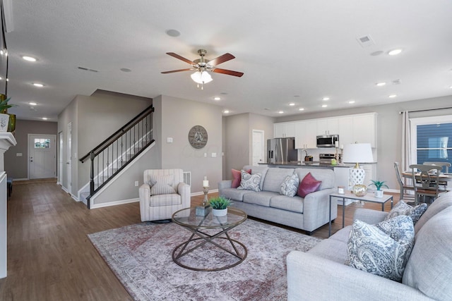 living room with ceiling fan, dark hardwood / wood-style flooring, and sink