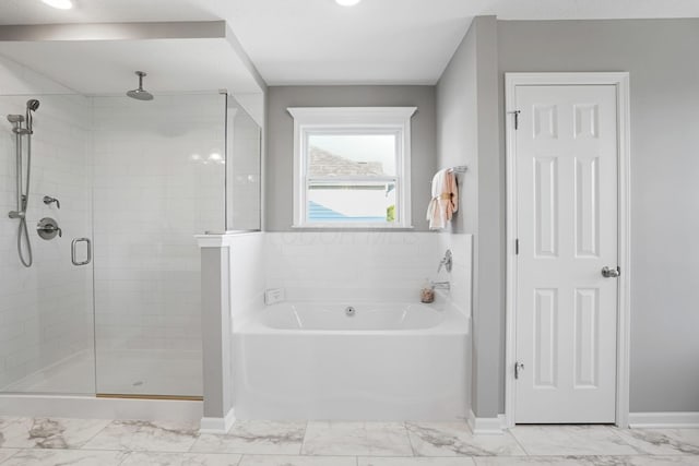 bathroom featuring separate shower and tub