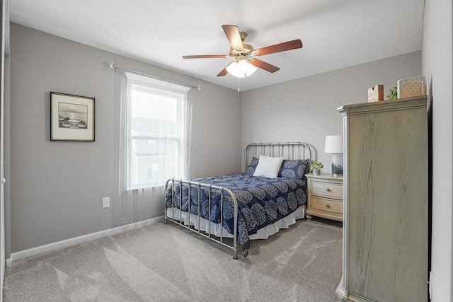 bedroom with ceiling fan and carpet flooring