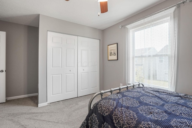 bedroom featuring carpet floors, a closet, and ceiling fan