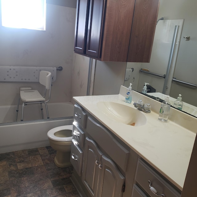 full bathroom featuring vanity, washtub / shower combination, and toilet