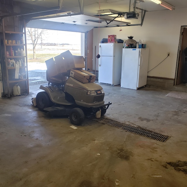 garage with white refrigerator and a garage door opener