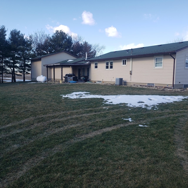 back of house with central AC unit, a pergola, and a lawn