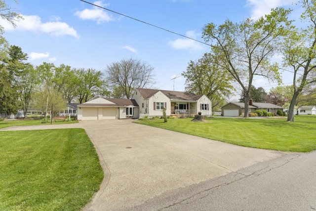 view of front of house with driveway, a front yard, and a garage