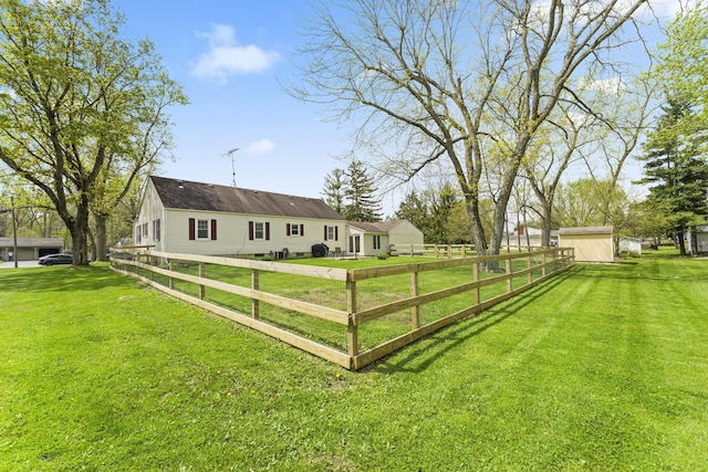 view of yard with fence and an outbuilding