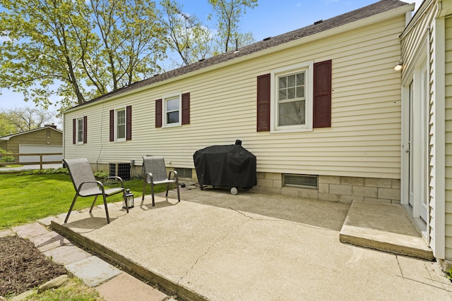 back of property with a yard, central AC, and a patio area