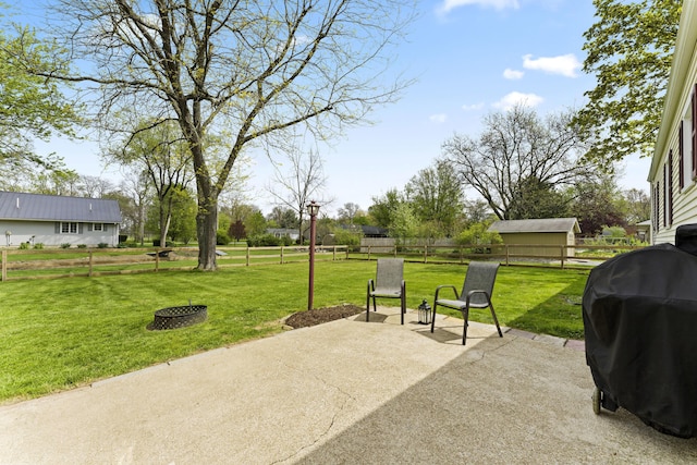 view of patio with area for grilling and fence