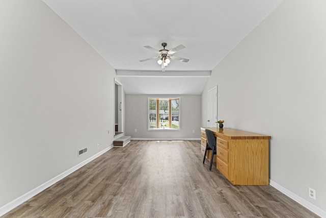 unfurnished living room with baseboards, a ceiling fan, wood finished floors, and visible vents