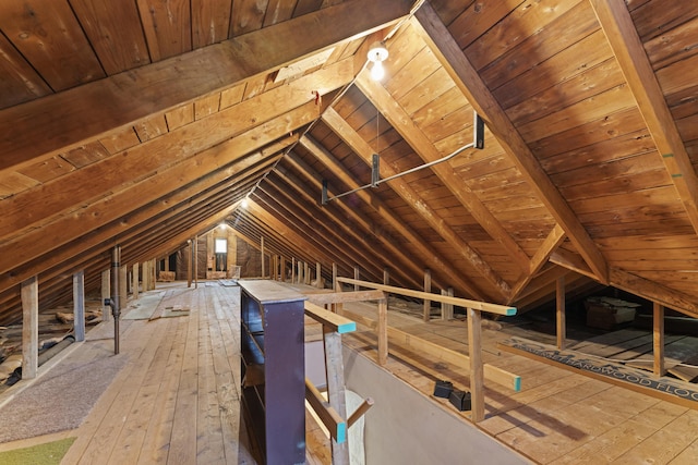 unfinished attic with an upstairs landing