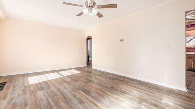 unfurnished room with hardwood / wood-style floors, ornamental molding, sink, and ceiling fan