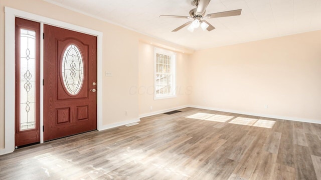 entrance foyer with ceiling fan, ornamental molding, and light hardwood / wood-style floors