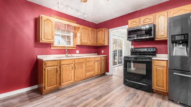 kitchen featuring sink, light hardwood / wood-style flooring, and stainless steel appliances