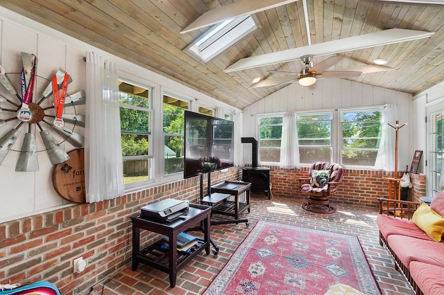 sunroom with a wood stove, vaulted ceiling with skylight, and wooden ceiling