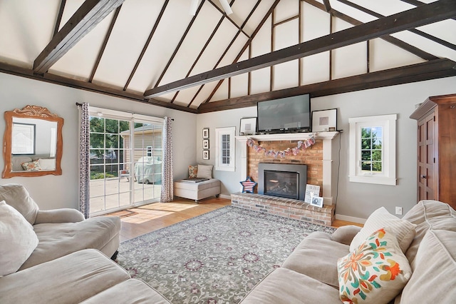 living room featuring a brick fireplace, beam ceiling, light hardwood / wood-style flooring, and high vaulted ceiling