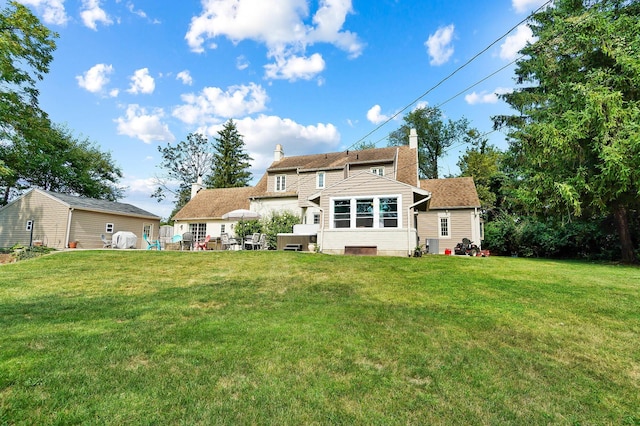 back of property featuring a yard