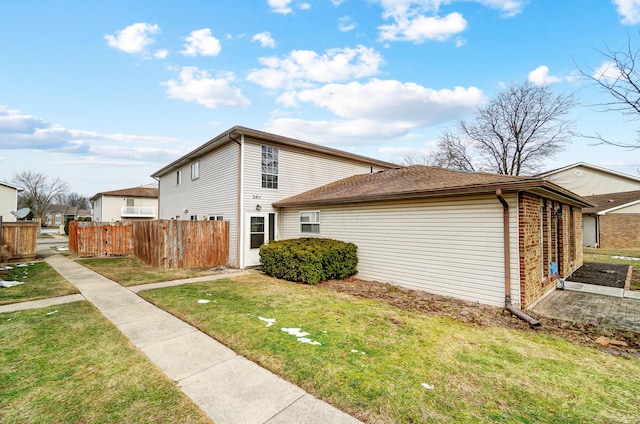 view of side of home with a lawn