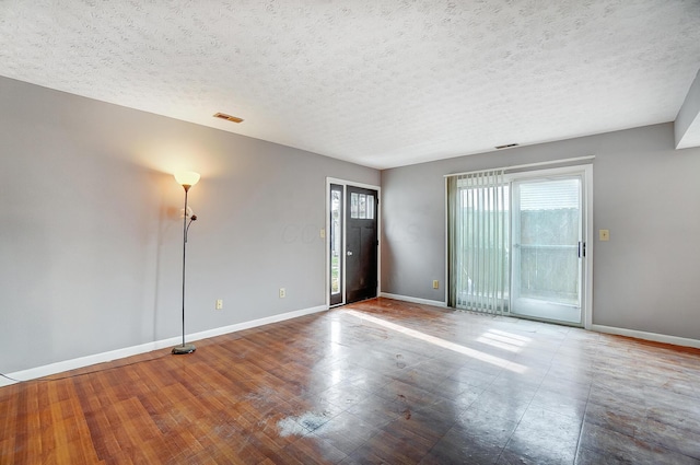 unfurnished room with a textured ceiling