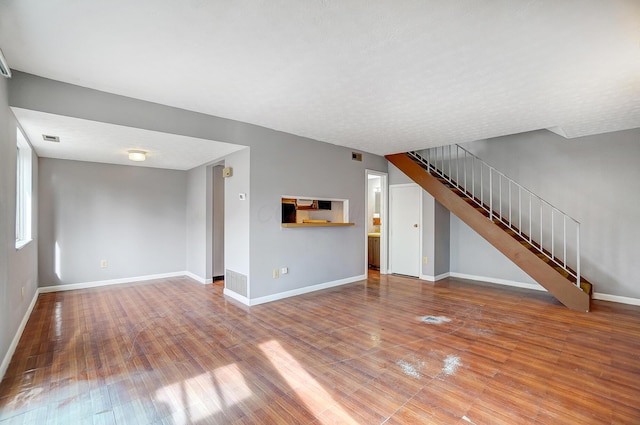 unfurnished living room with hardwood / wood-style flooring