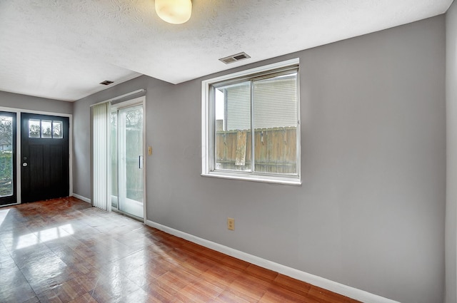 entryway with a textured ceiling