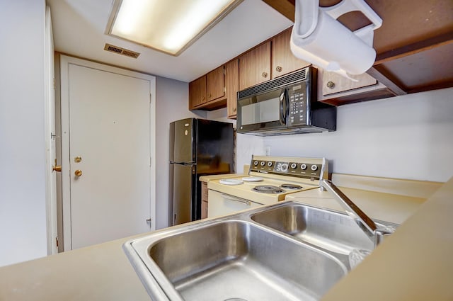 kitchen featuring sink and black appliances