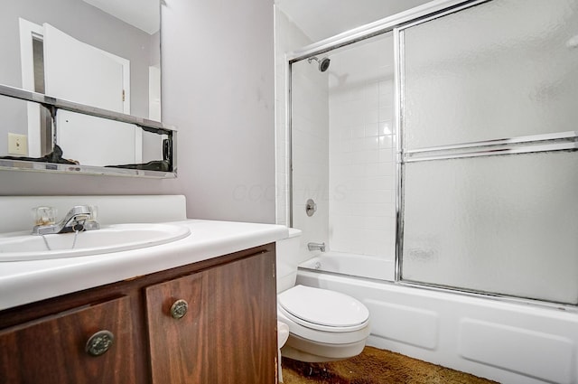 full bathroom featuring vanity, shower / bath combination with glass door, and toilet