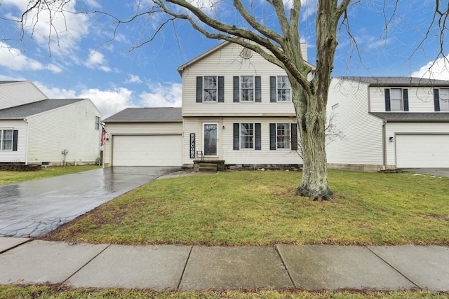 view of front of house with a garage and a front lawn